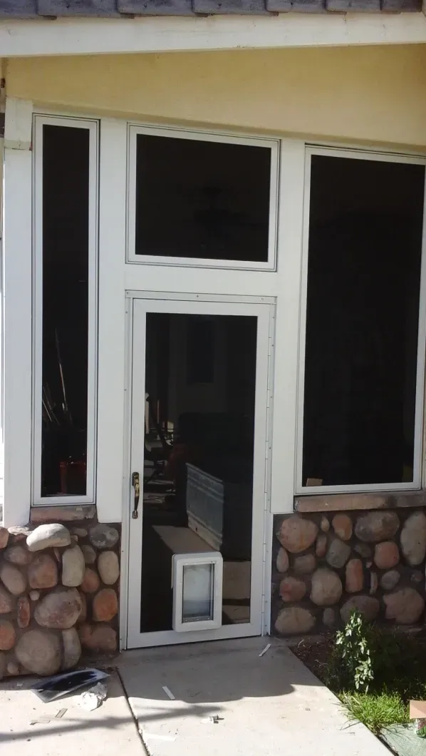 A screened in porch with a dog door