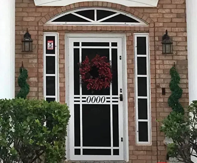 The front door of a house with a wreath on it.