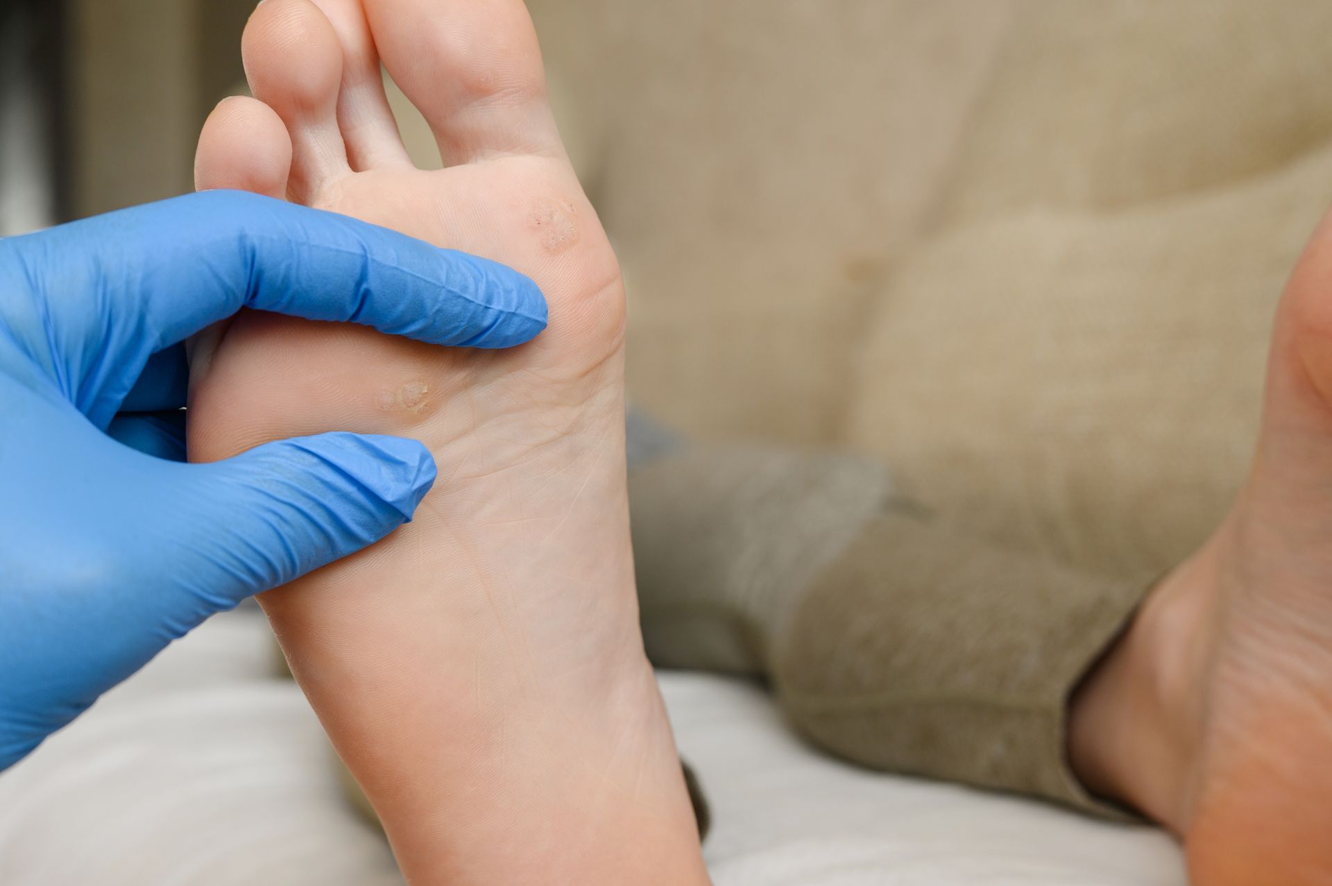 Medical professional examining bottom of foot