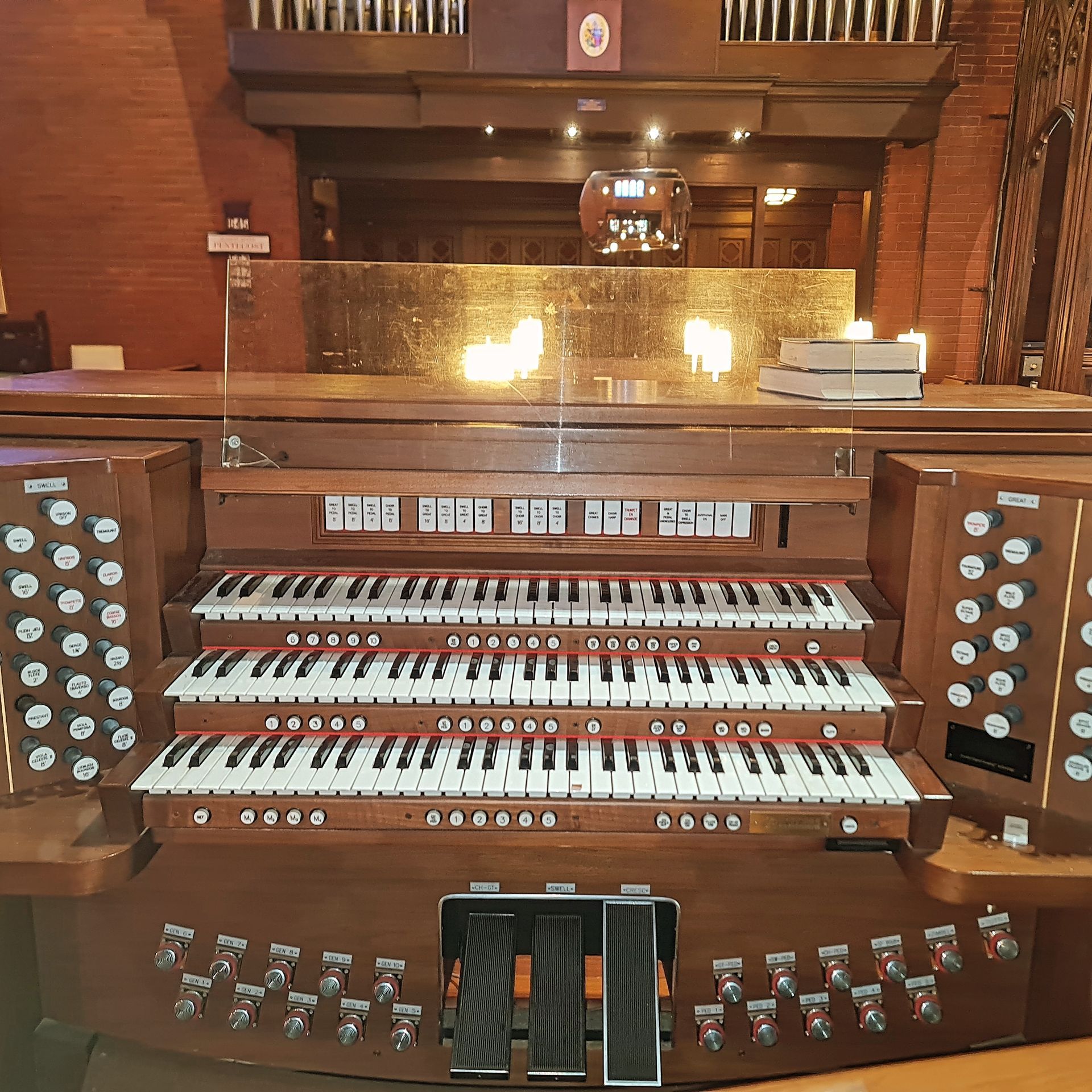 Pipe organ with multiple keyboards and pedals, in a church.