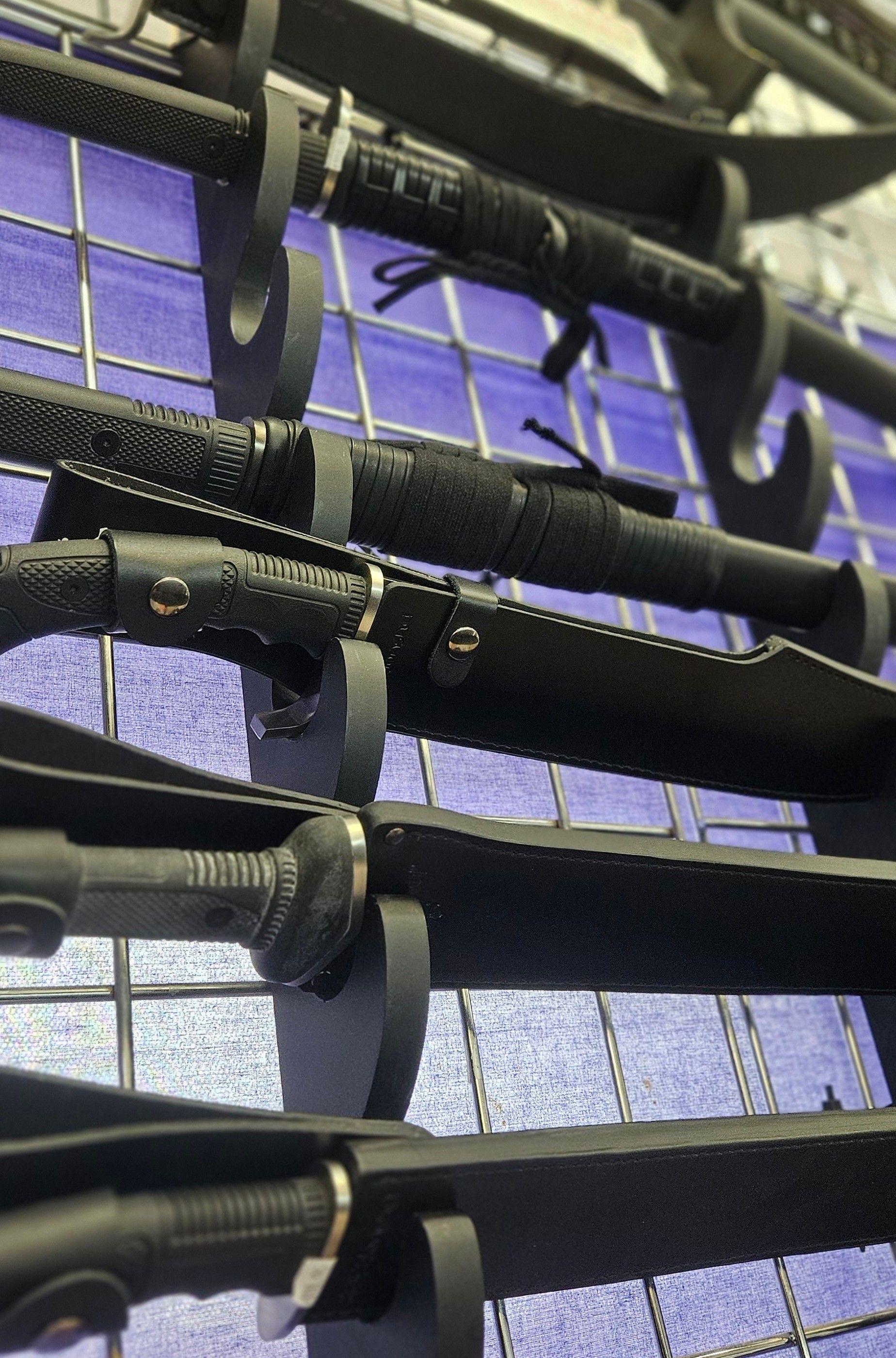 A sword rack is stacked with katanas and other battle-ready swords.