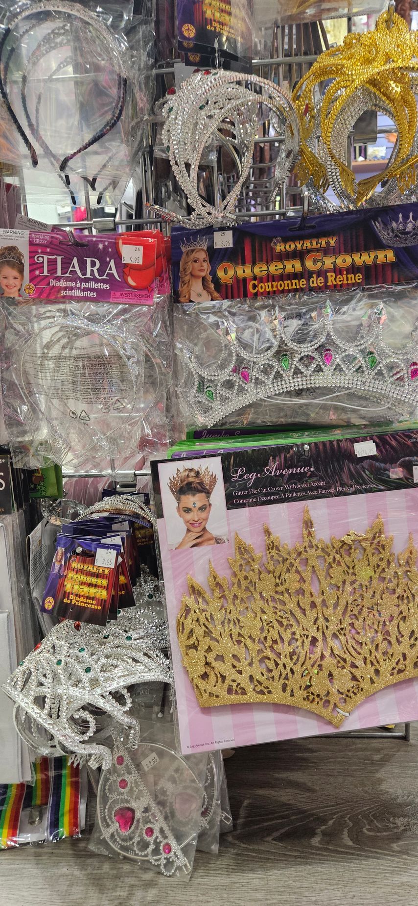 A display of party and dress up supplies featuring several tiaras and headwear.