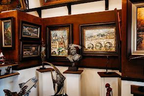 A room filled with paintings and sculptures on display.