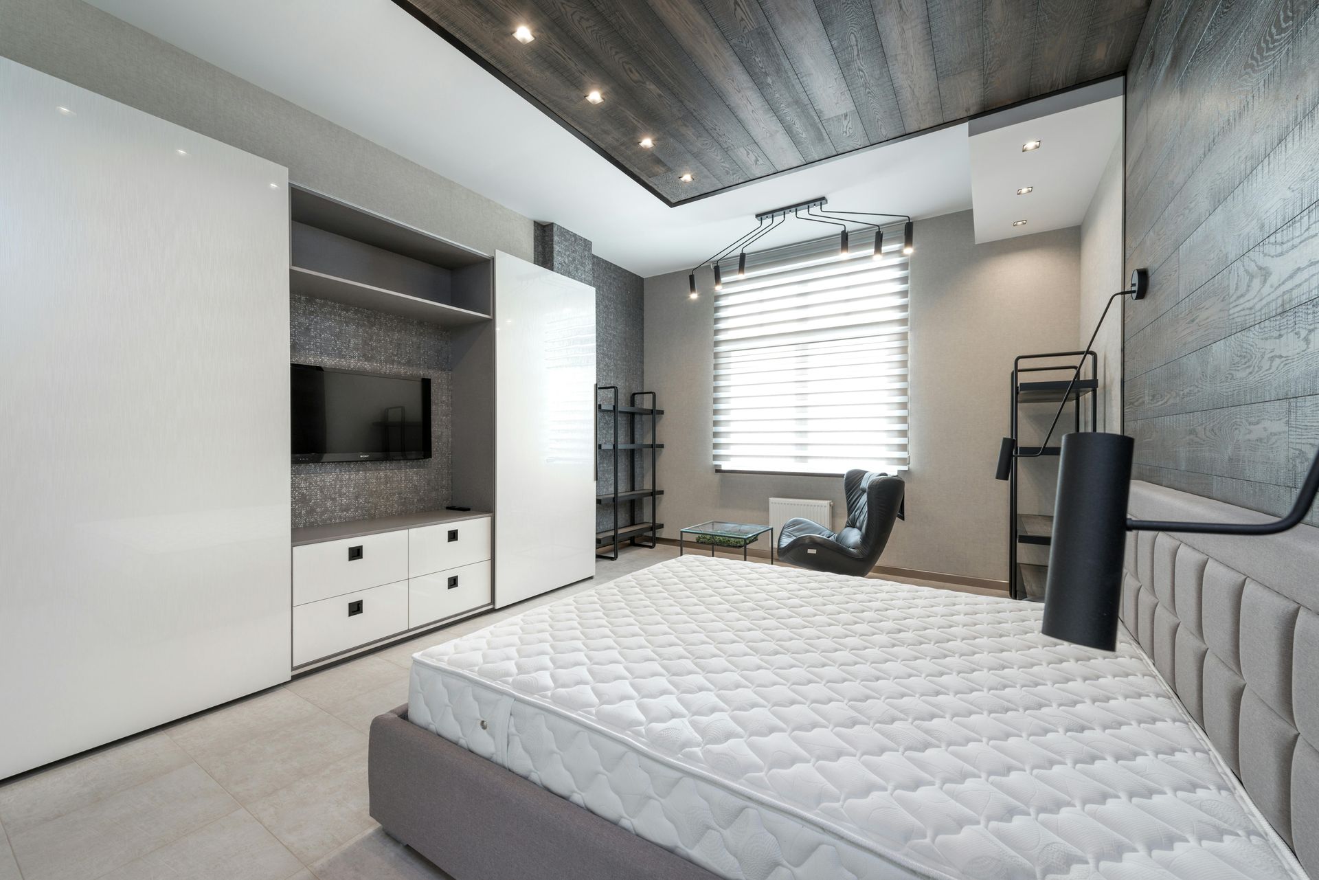 There is a mattress on the bed in the middle of the room.