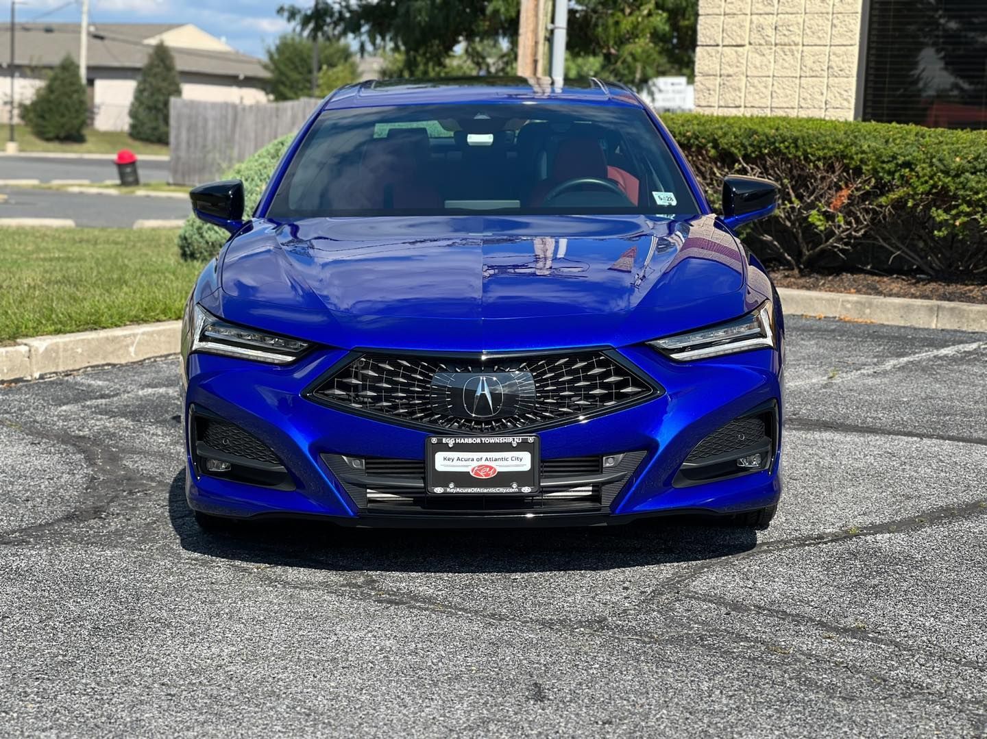 A blue acura integra is parked in a parking lot.