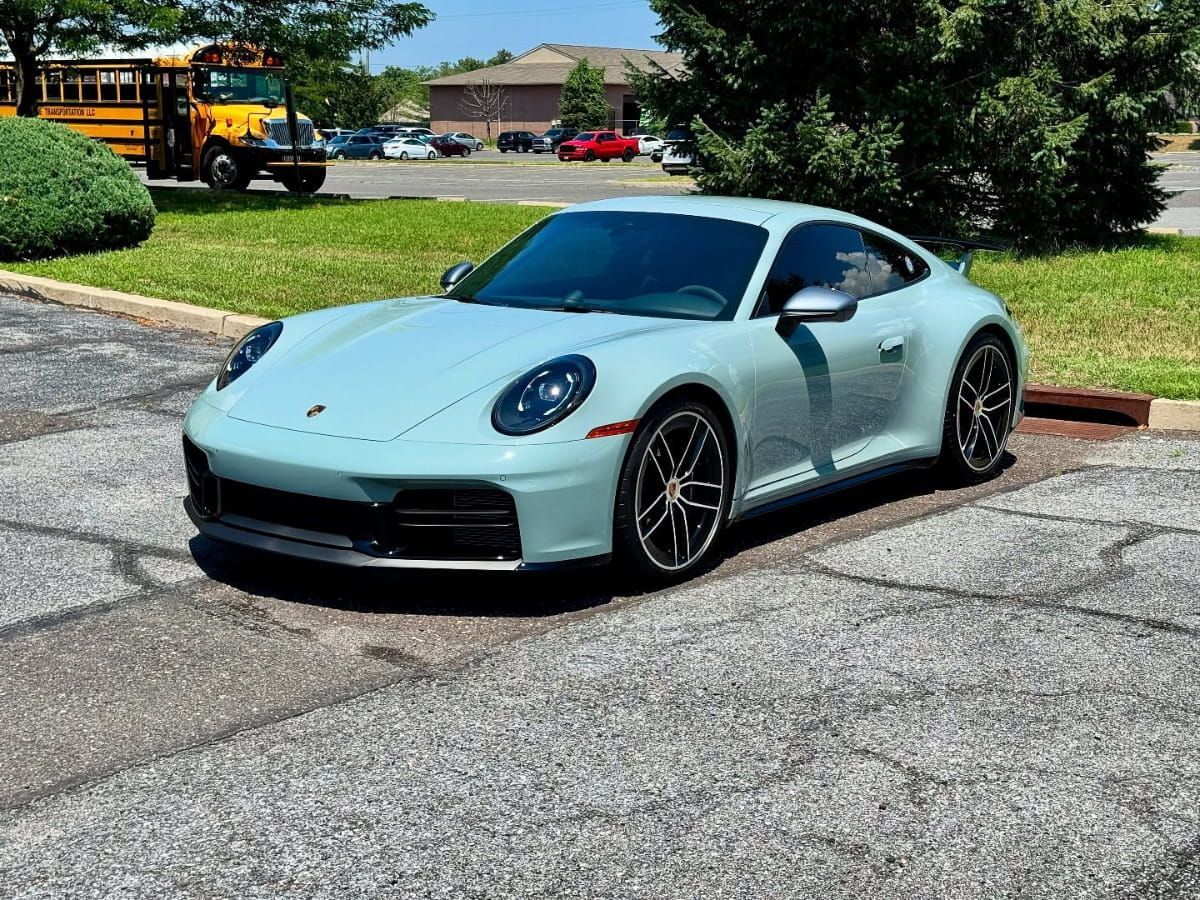 Light blue Porsche sports car parked outdoors with a clean, glossy finish.
