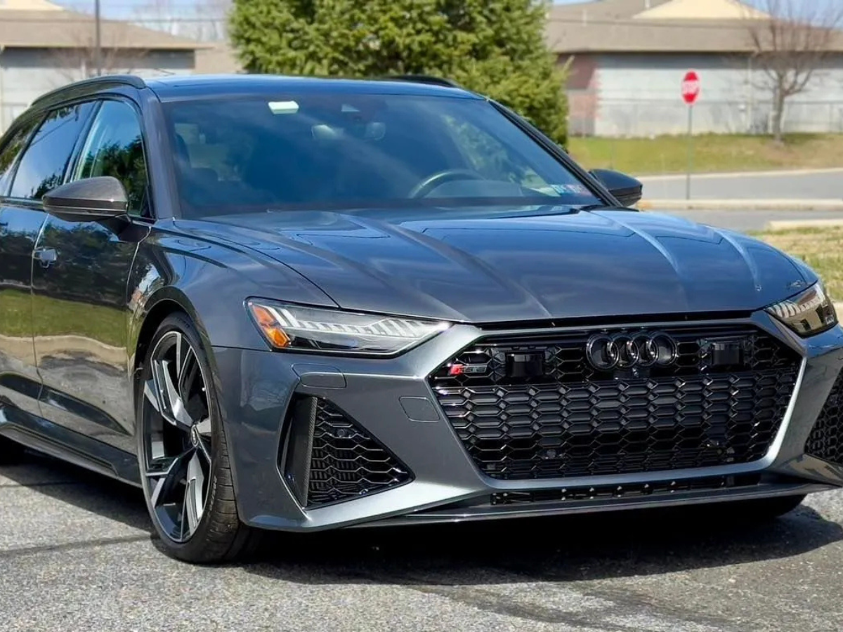 Gray Audi RS6 Avant wagon with gloss black honeycomb grille and sport alloy wheels in parking lot
