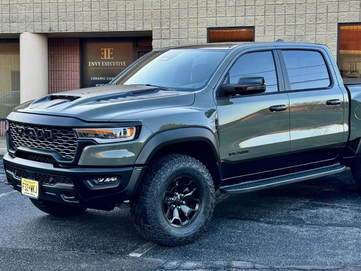 Green Ram 1500 parked outside Envy Executive Automotive Protection.