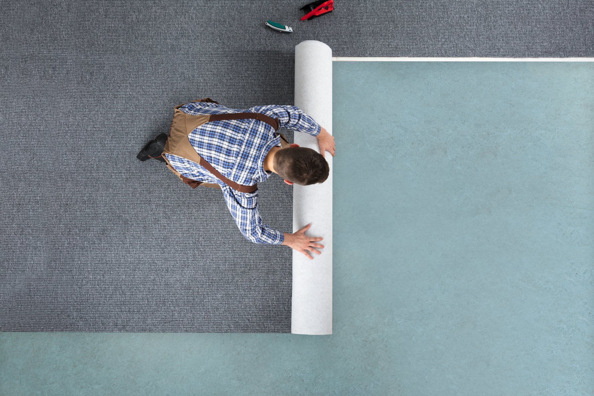 A Man Rolling The Carpet - Altoona, WI - Dreamhouse Interiors