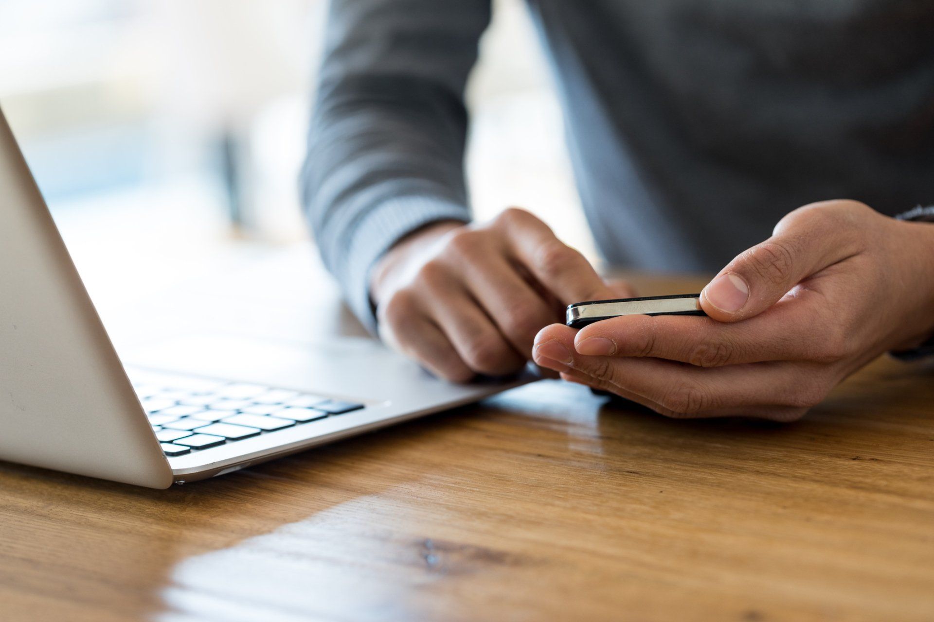 A Man With Phone And Laptop In The Table- Altoona, WI - Dreamhouse Interiors