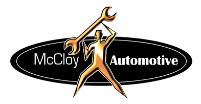 Gold figure holding a wrench above its head, logo for McCloy Automotive.
