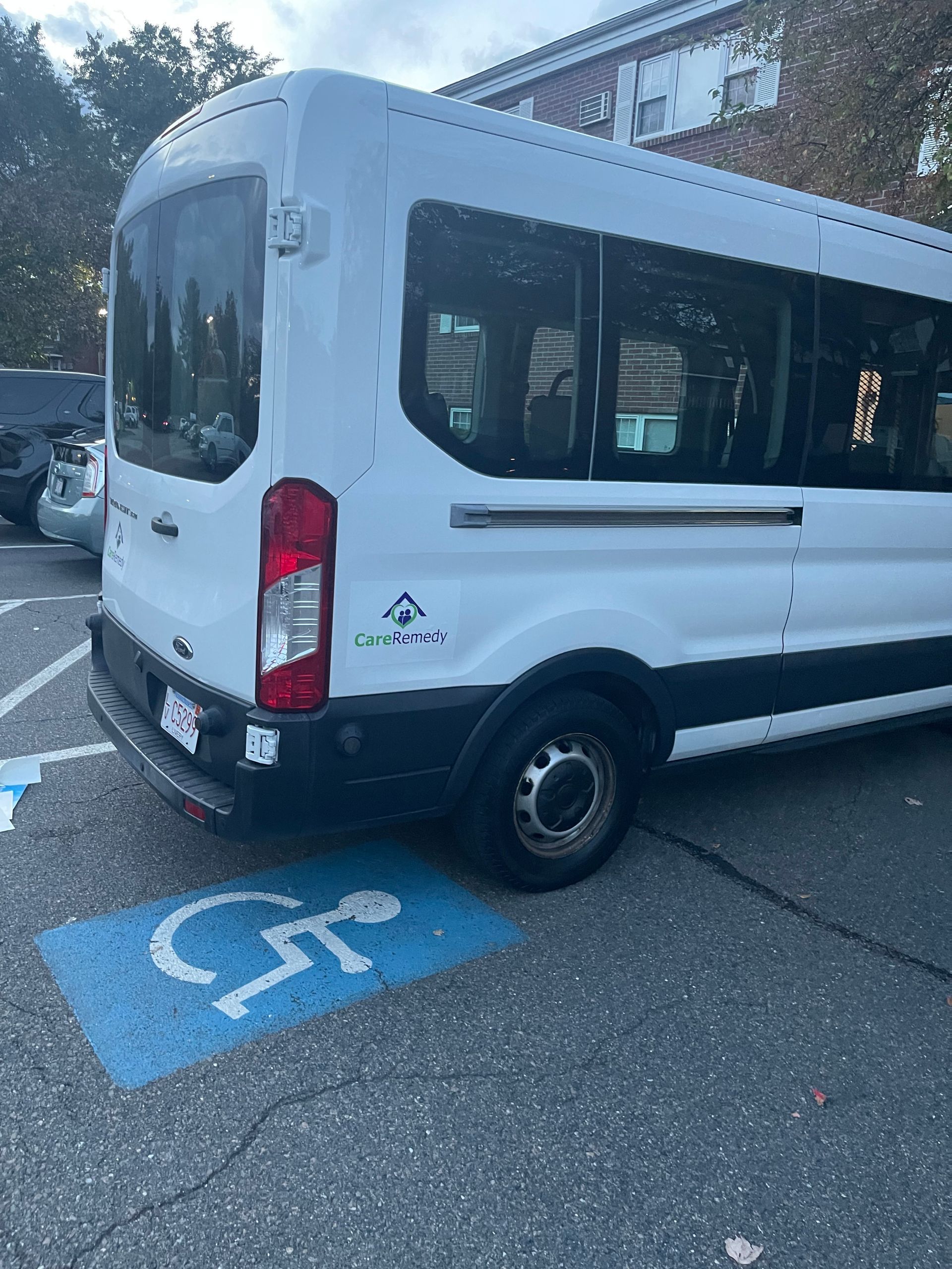 Aides assisting a wheelchair user at a home entrance in Wakefield Massachusetts