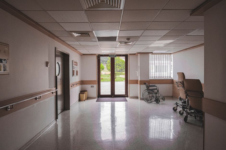 Older patient leaving the hospital in a wheelchair at discharge