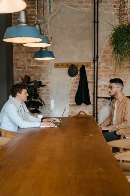 Consumer interviewing a personal care attendant at a kitchen table