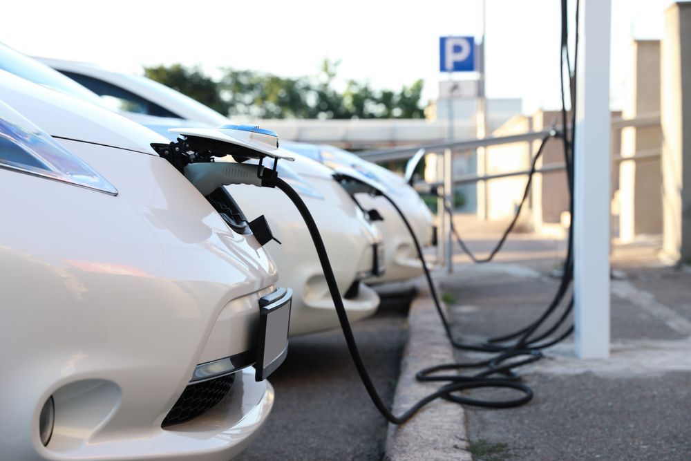 A row of electric cars are being charged at a charging station — CWC Auto Services In Ainslie, ACT