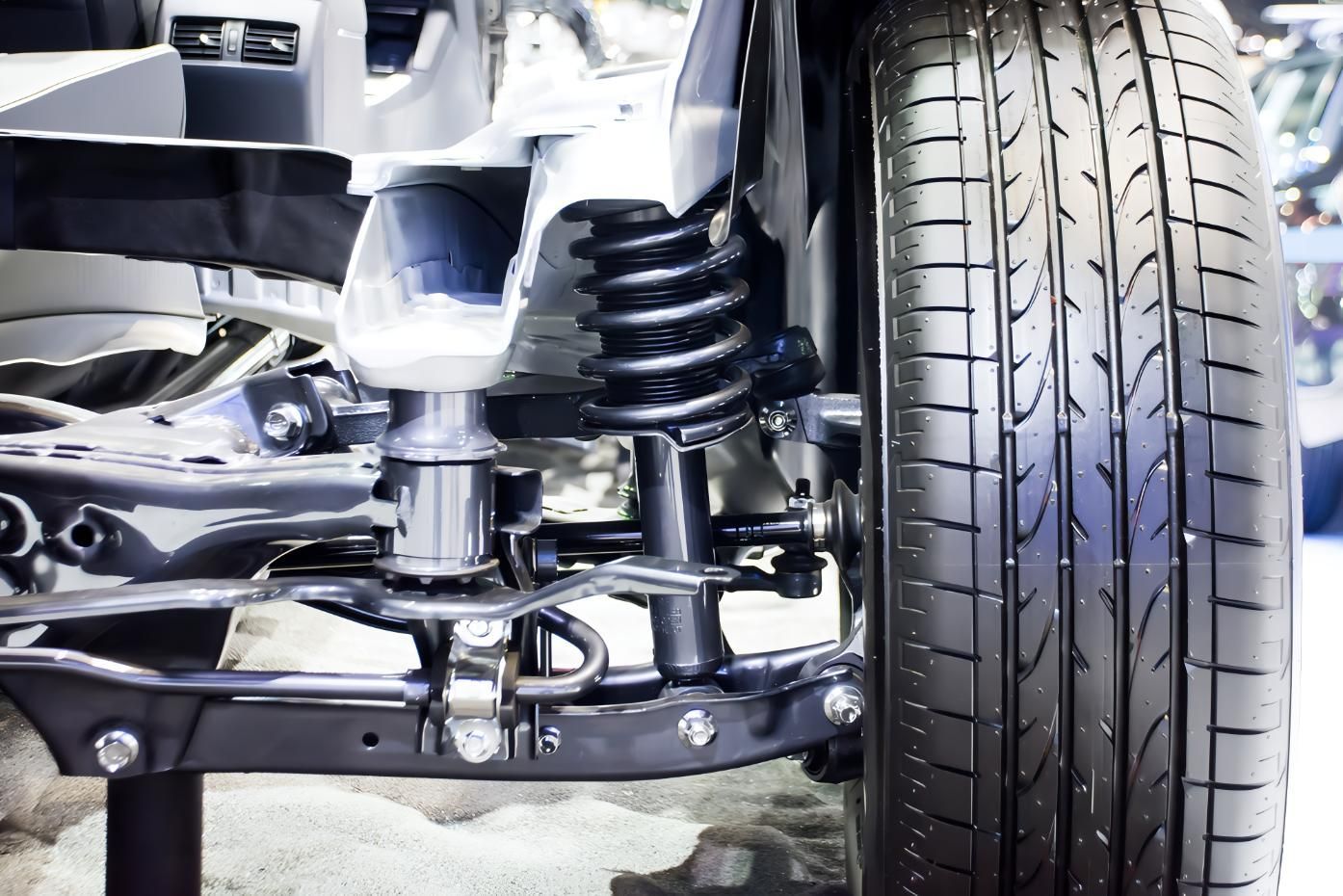 A Close Up of a Car Suspension With a Tire in the Background — CWC Auto Services In Ainslie, ACT