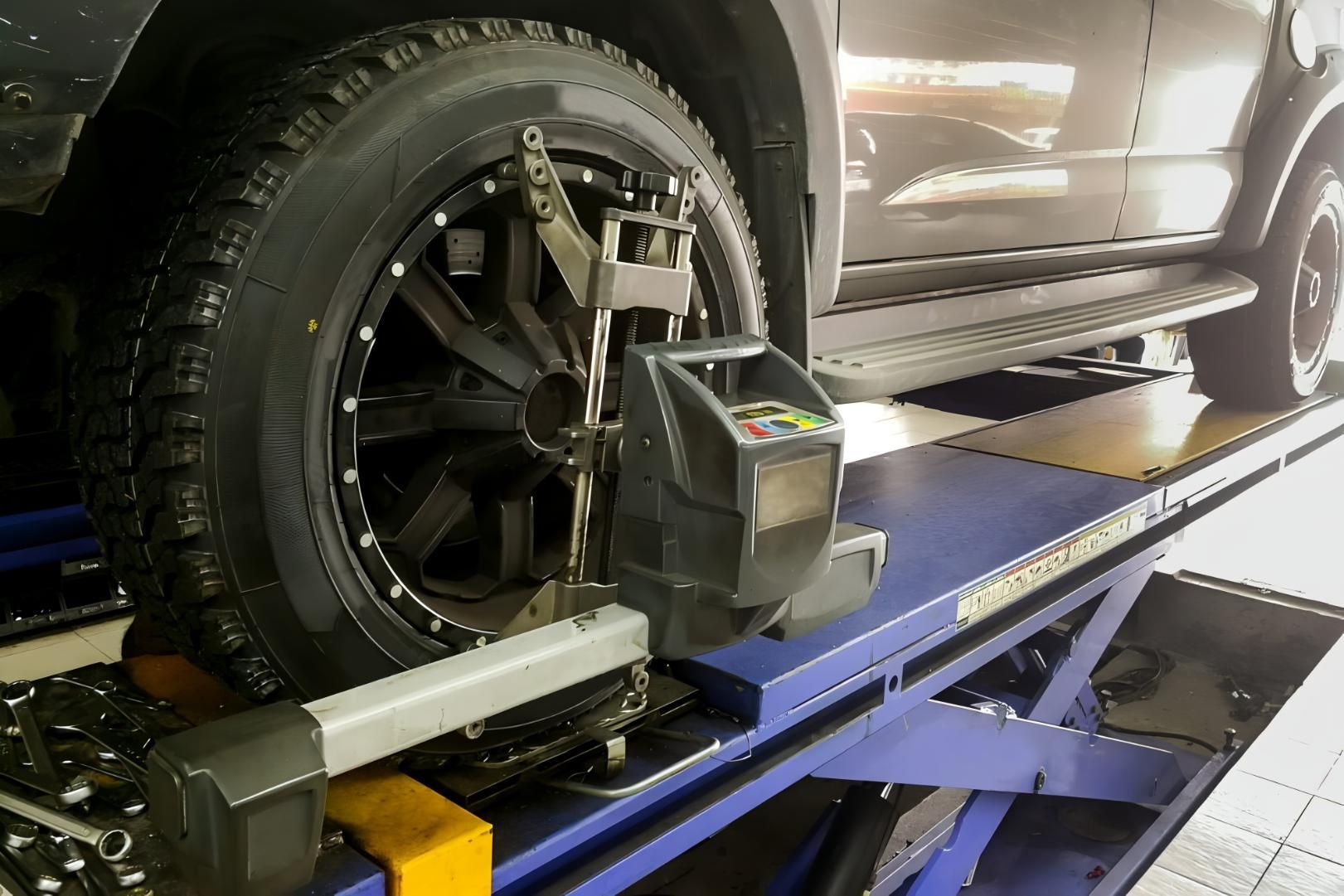 A Tire Of A Car With A Tool Attached — CWC Auto Services In Ainslie, ACT