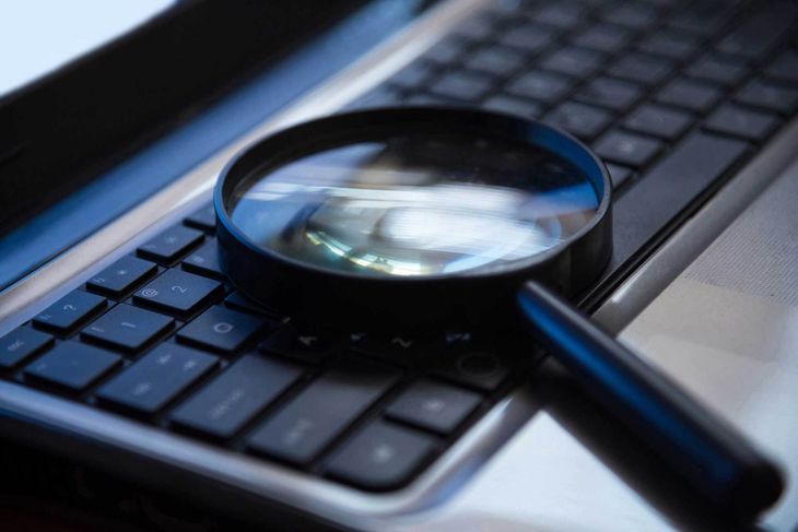 Magnifying glass on the keyboard — Marina del Rey, CA — Garrett & Associates
