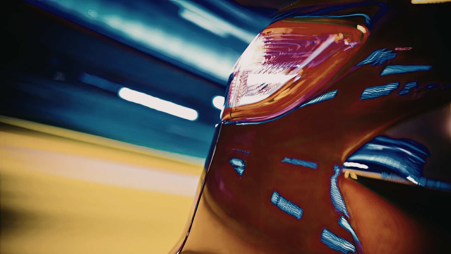 Close-up of a red car speeding at night with motion-blurred lights in the background