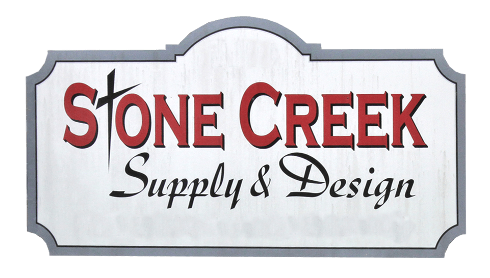 Sign for Stone Creek Supply & Design, with red text on a silver background, and a gray border.