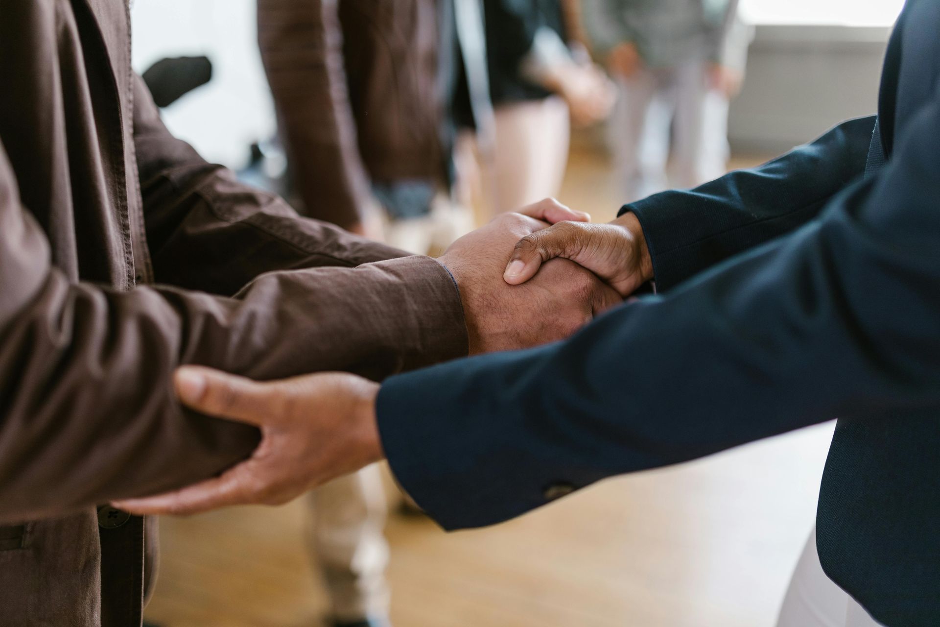 A group of people are shaking hands in a room.