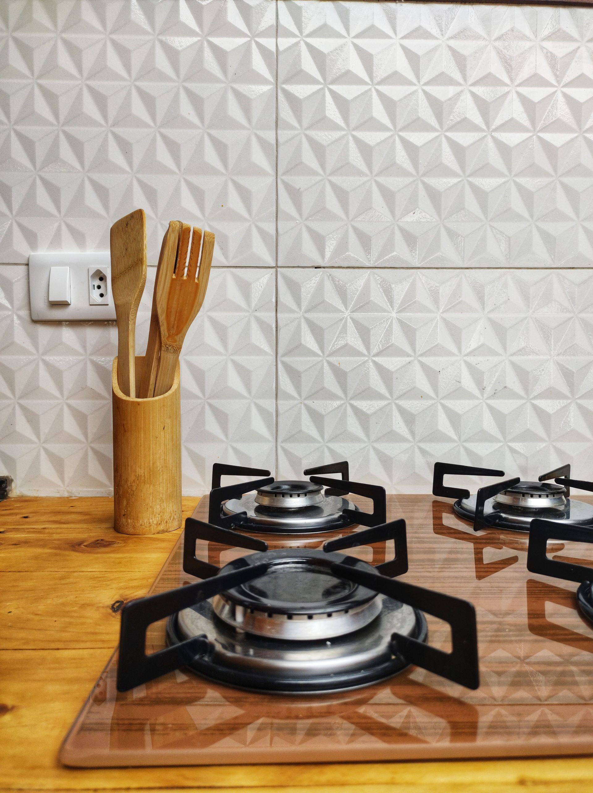 A modern kitchen features white cabinets, granite countertops, a stainless steel microwave and stove, and double windows.