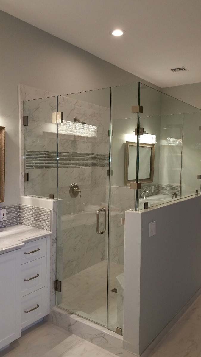 Modern bathroom with a glass shower enclosure and white vanity.