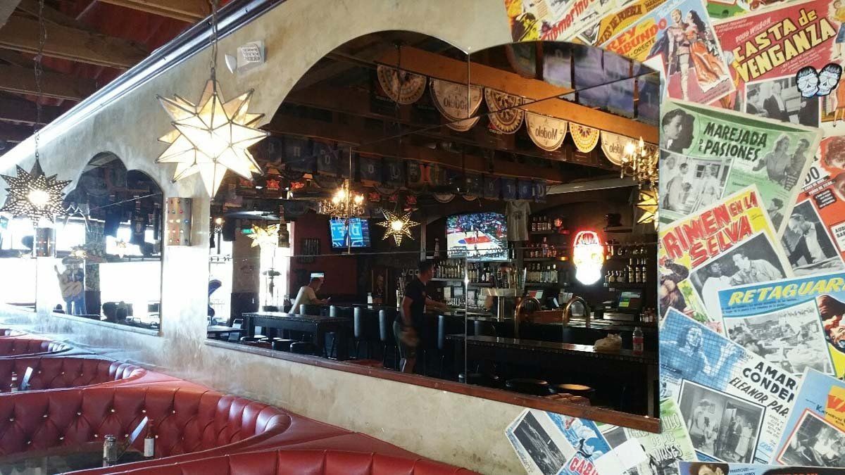 Colorful retro diner booth with mirrored bar, hanging star lamp, and comic-covered wall decor