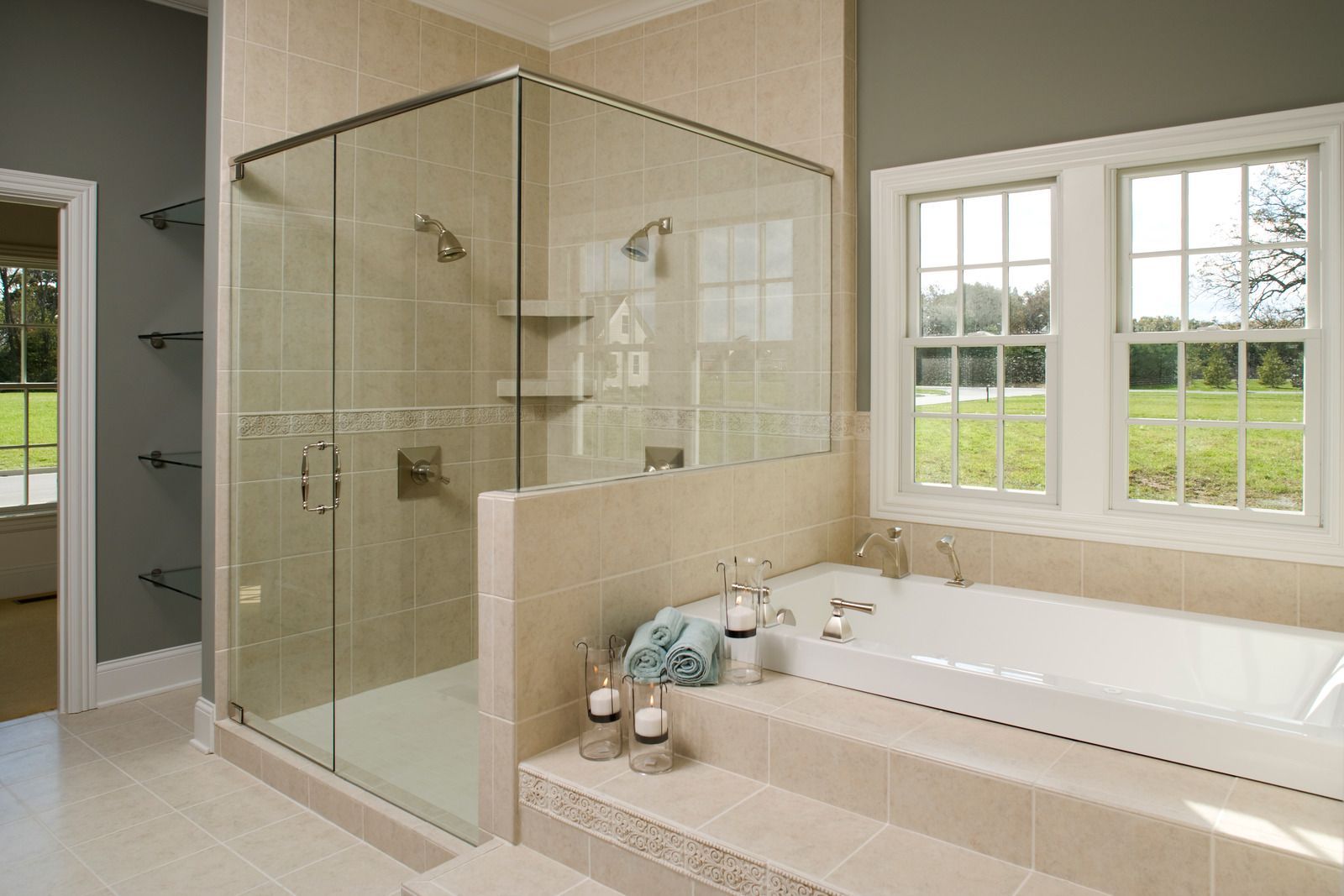 A bathroom with a tub , shower , and window.