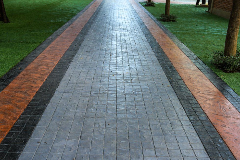 Pathway With Stamped Concrete, Bordered by Orange and Black — Comet Concreting in Drayton, QLD