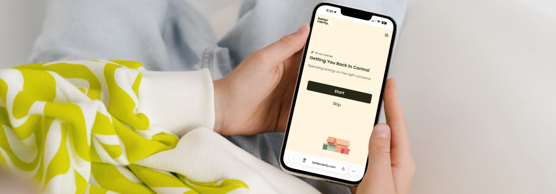 Person holding a phone with an app open, showing text, against a light background.