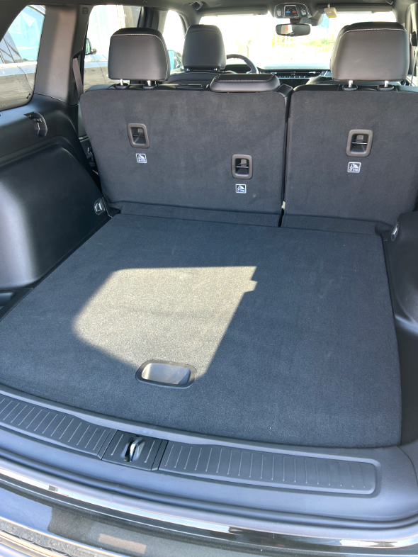 The back of a car with the trunk open and the seats folded down.
