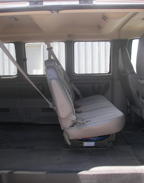 The back seat of a van has a seat belt on it