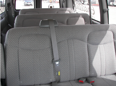 The back seat of a van has a seat belt on it