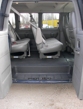 The back seat of a van with the door open