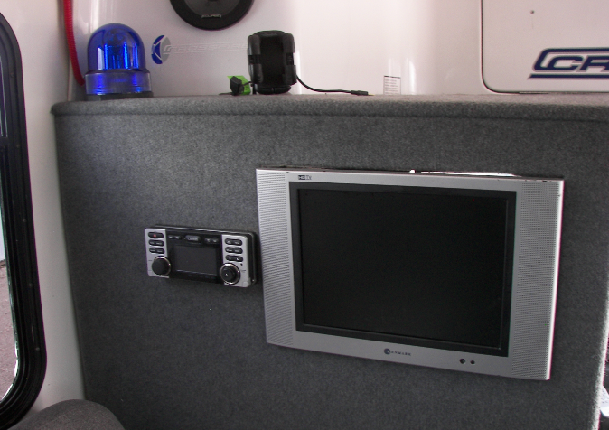 A tv mounted on a wall next to a radio