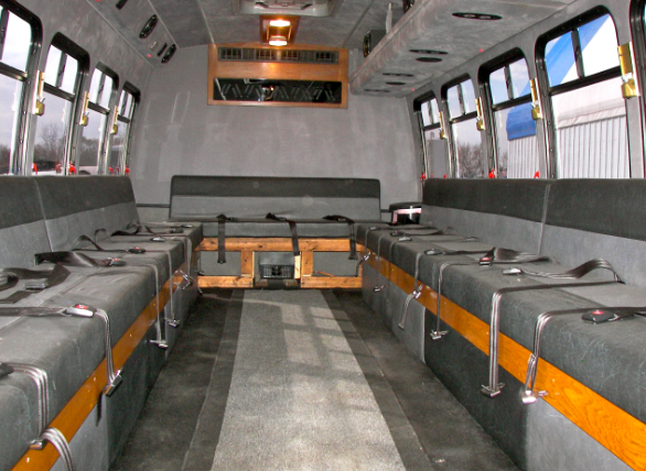 The inside of a bus with a lot of seats