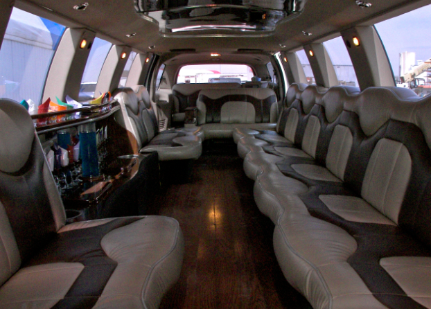 The inside of a limousine with lots of seats and a bar