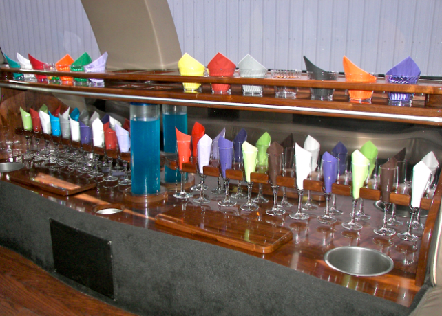 A bar with a lot of glasses and napkins on it