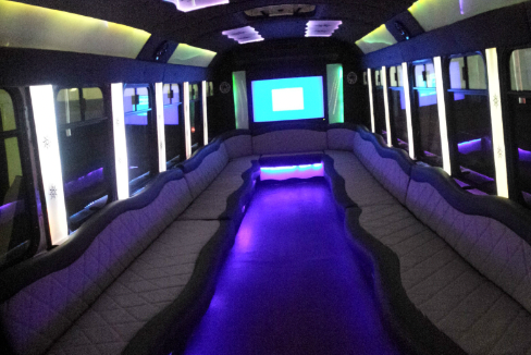 The inside of a limousine with purple lights