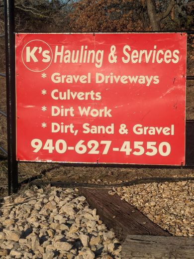 A red sign for k 's hauling and services