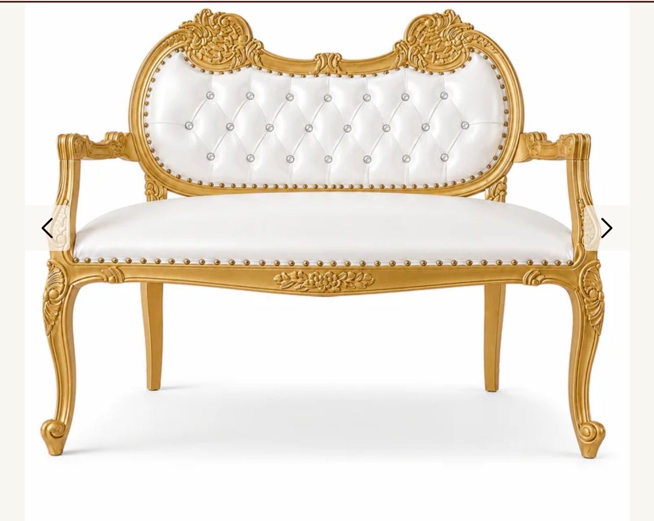Ornate gold and white tufted loveseat with carved wooden frame and curved arms