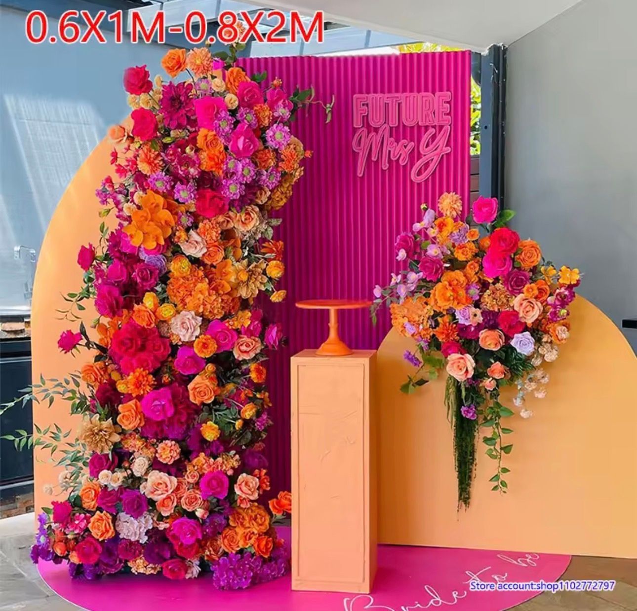 Colorful floral event backdrop with pink podium, bright flowers, and “Future Mrs” sign