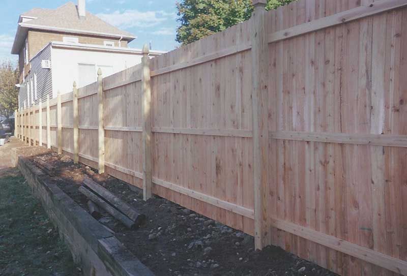 Wooden Fence is Being Built in Front of a House — Clifton, NJ — All Jersey Fence Co.