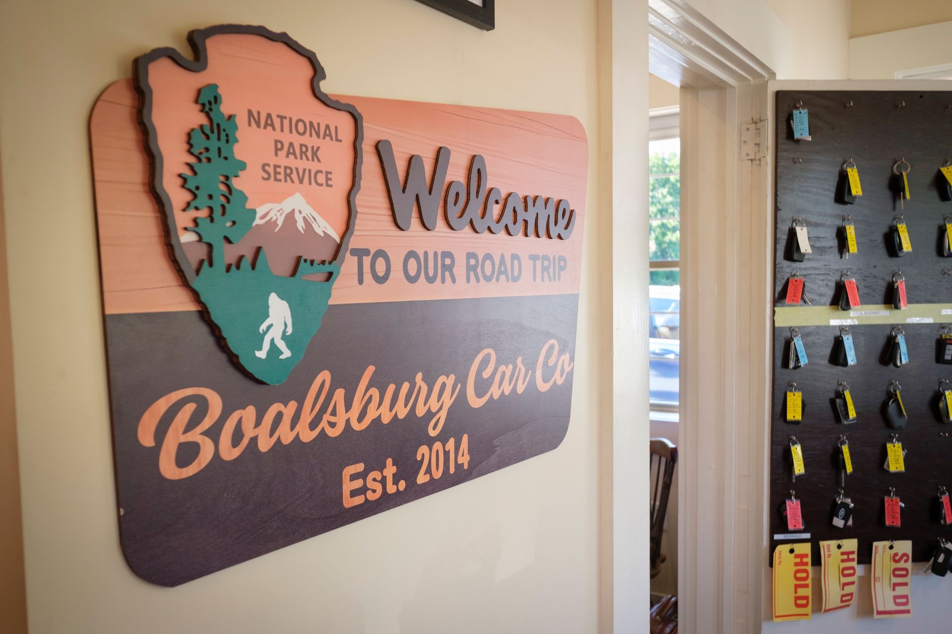 Wooden sign for Boalsburg Car Co., featuring the National Park Service arrowhead logo and