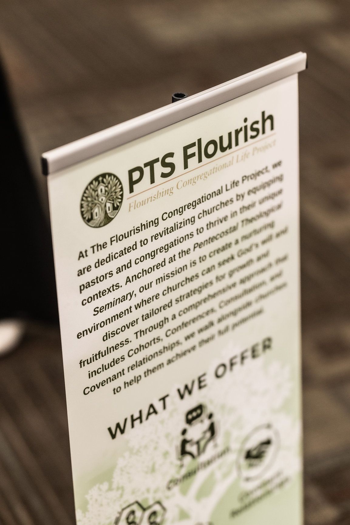 A sign that says `` what we offer '' is sitting on a table.