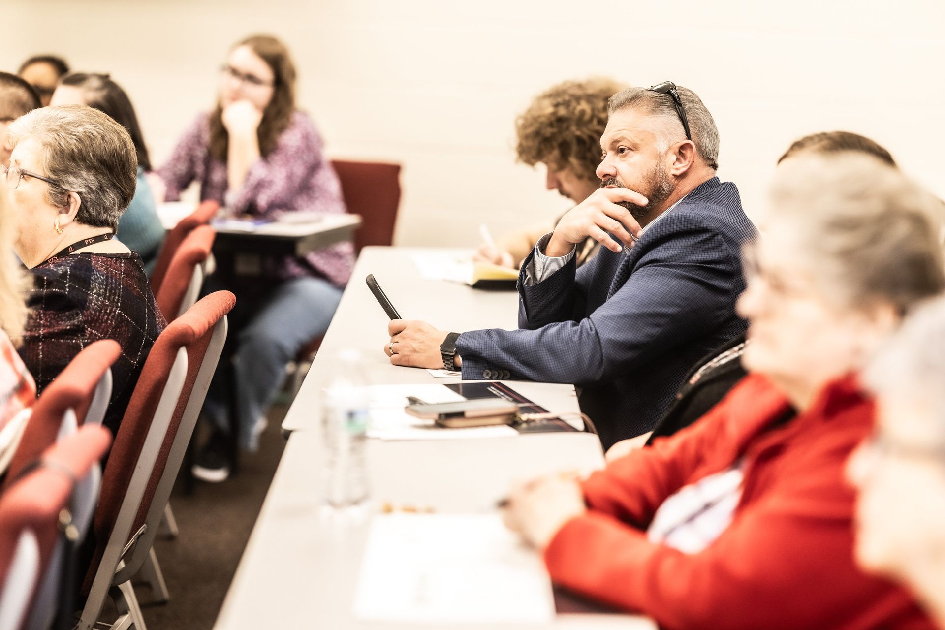 A group of people are sitting in a lecture hall.