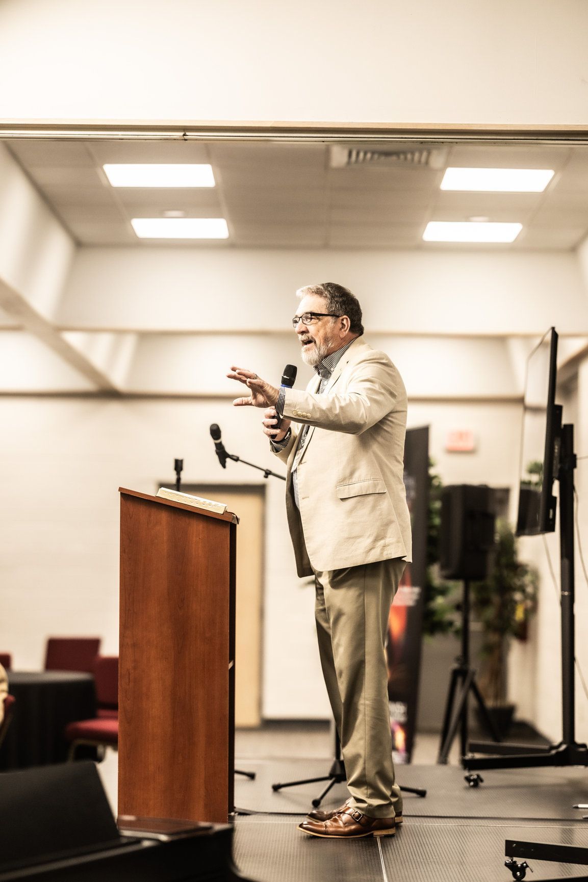 A man is standing at a podium giving a speech.