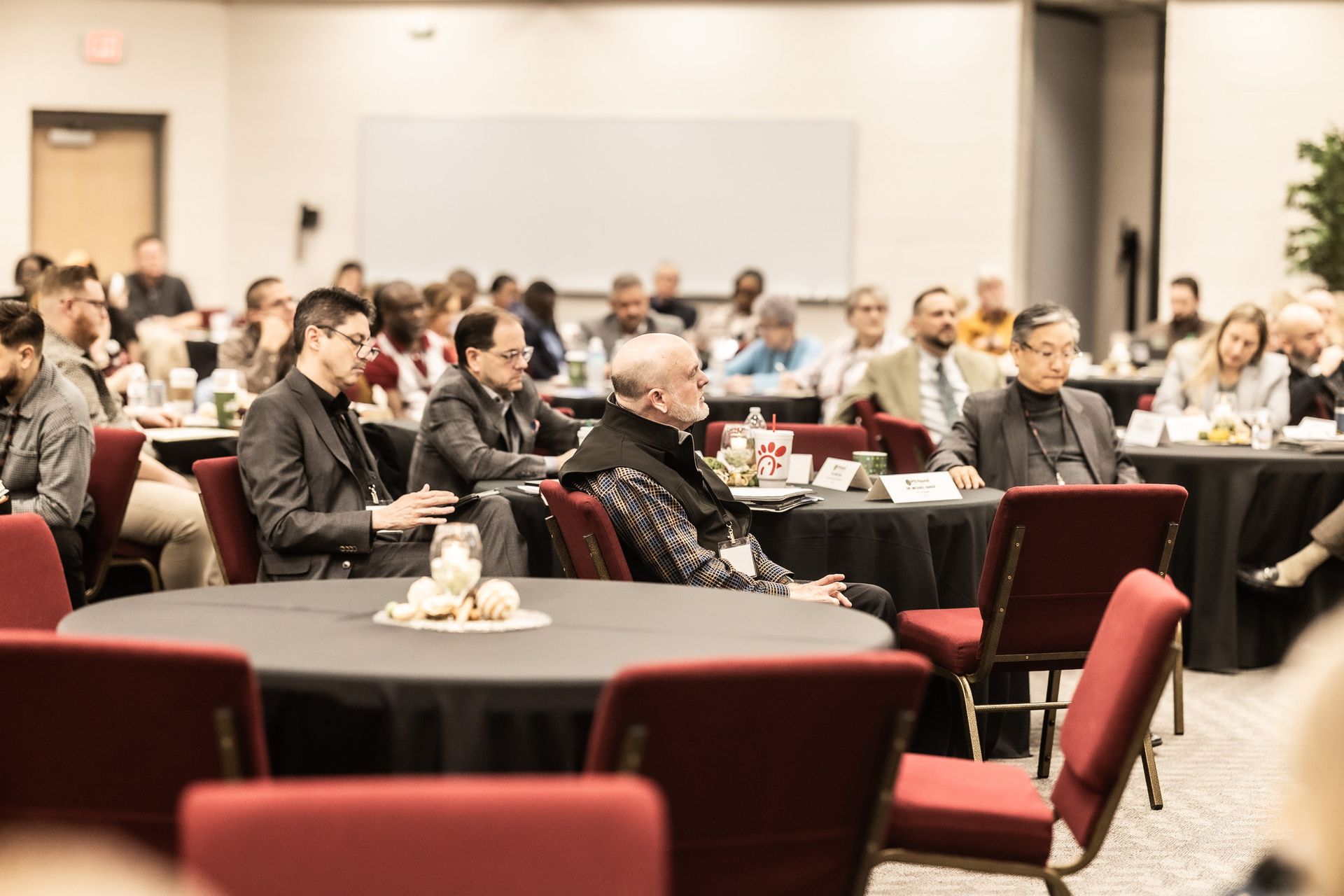 A group of people are sitting in a lecture hall.