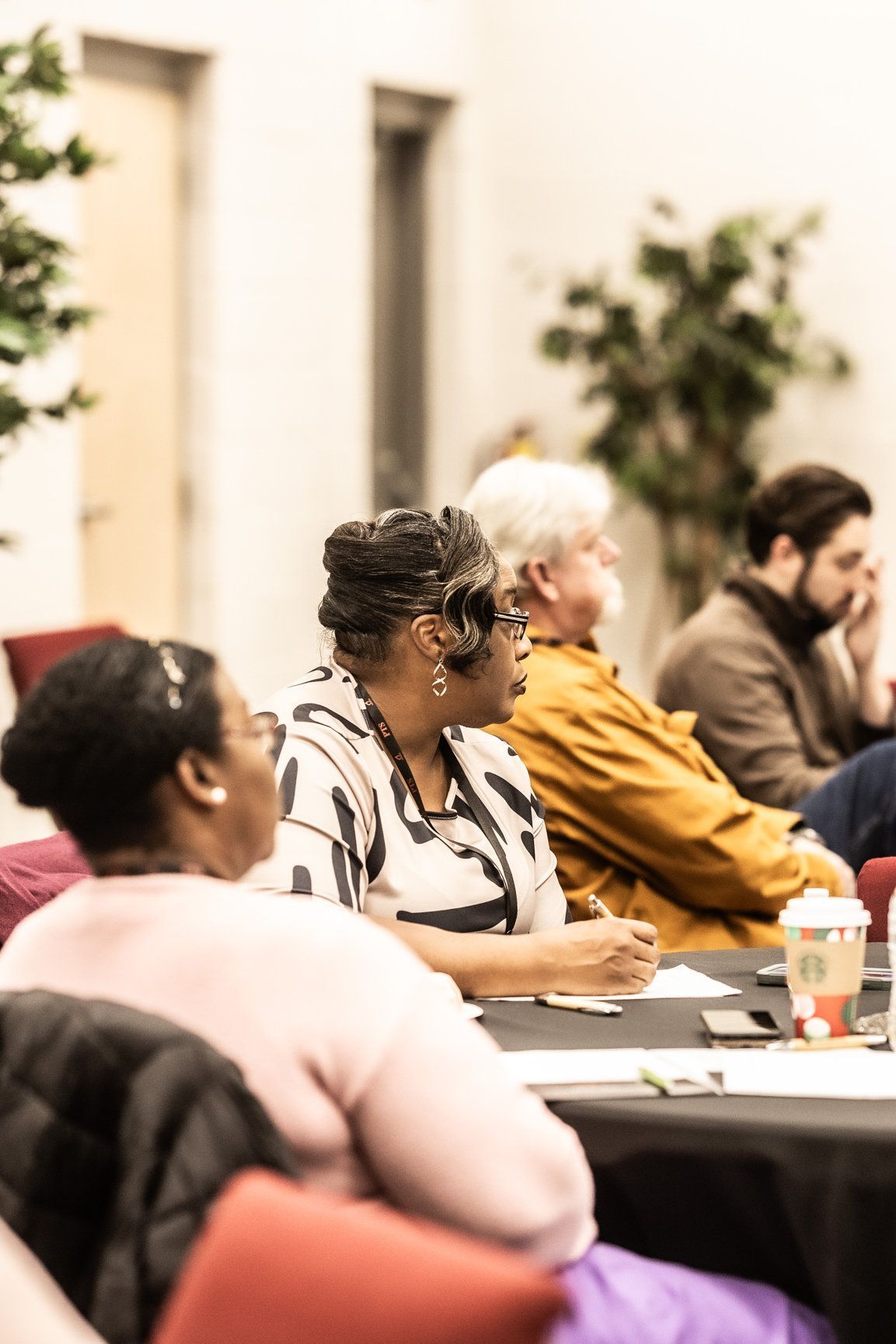 A group of people are sitting at a table in a room.
